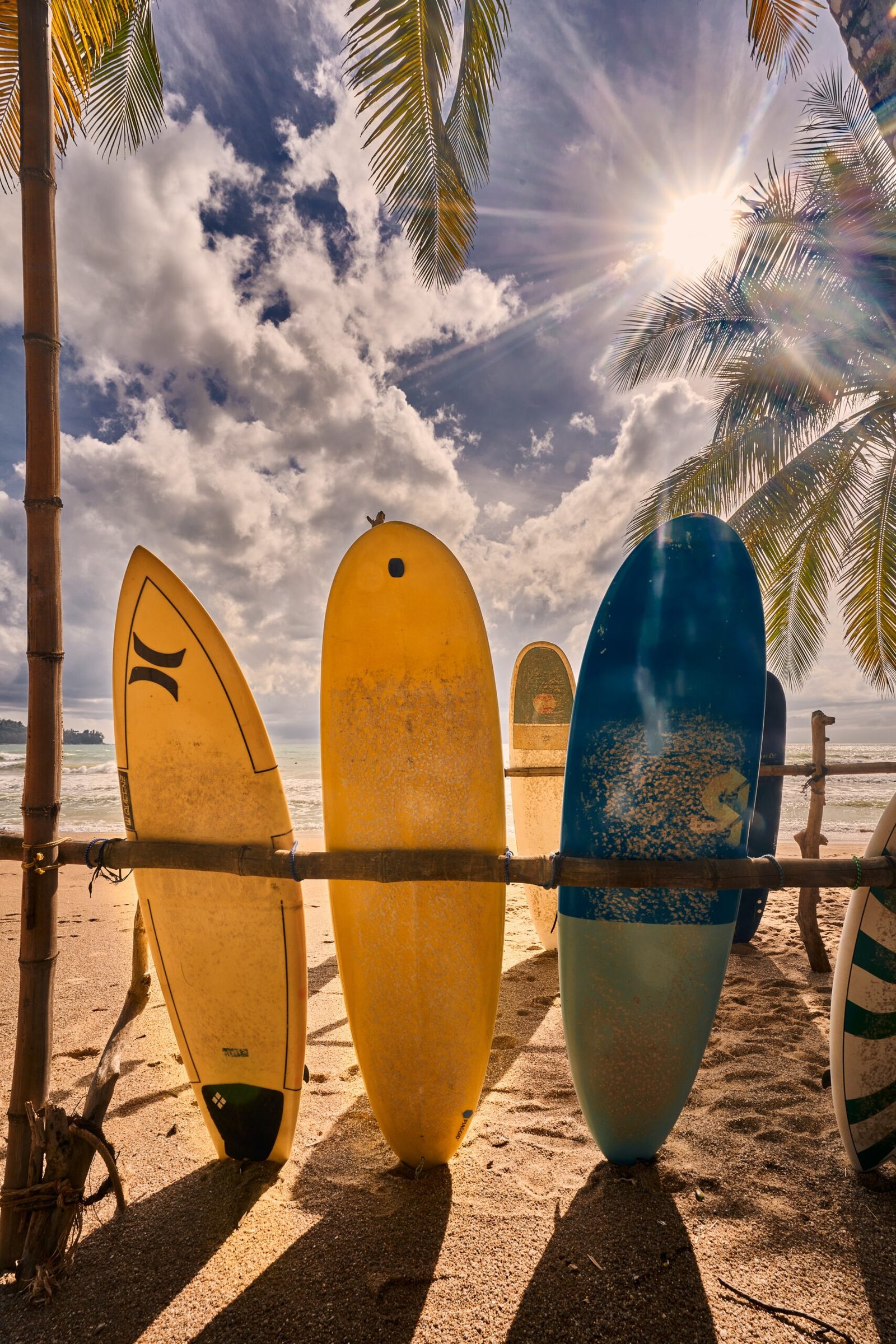 a group of surfboards on a beach